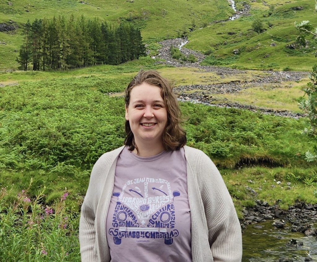 Jennifer standing in teh countriside of Wales, her new home.